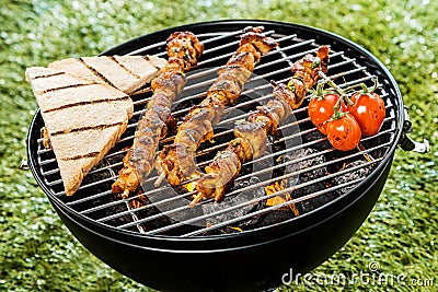 Delicious meat kebabs grilling on a BBQ fire Stock Photo