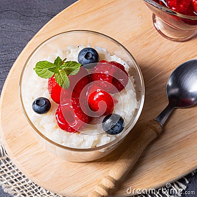 Delicious milk rice with different berries and red fruit jelly Stock Photo