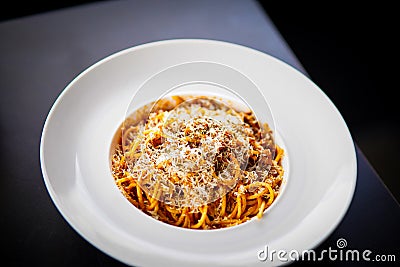 Tasty minced beef spaghetti decorated with parsley on white plate stock photo Stock Photo