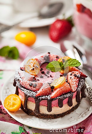 Delicious mini cheesecake decorated with berries and chocolate Stock Photo