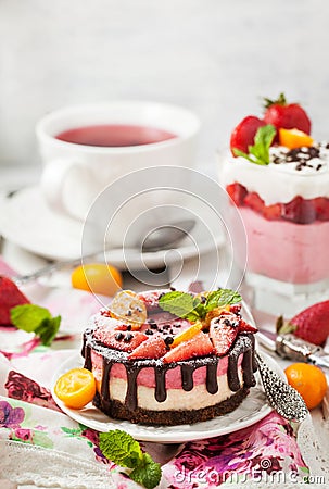 Delicious mini cheesecake decorated with berries and chocolate Stock Photo
