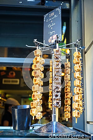 Delicious mini waffles dessert with varieties of topping on sticks selling in front of ice cream shop Stock Photo