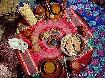 Delicious Moroccan dinner on beautifully decorated rooftop terrace. Imlil valley, Morocco. Stock Photo