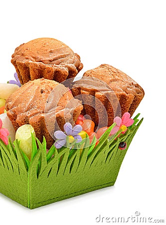 Delicious muffins, colorful caramels in the green basket Stock Photo