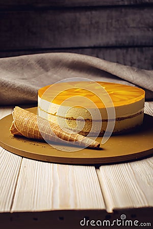Delicious multi-layered fruit mango cake stands on circular base Stock Photo