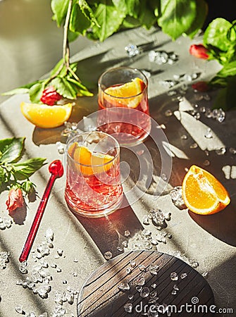 Delicious negroni cocktails with campari, gin, vermouth and slices of citrus orange and ice Stock Photo