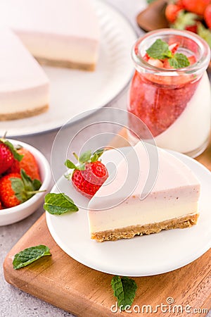 Delicious and nutritious handmade strawberry no bake frozen gradient colour fromage frais cheesecake slice with raw sarcocarp Stock Photo