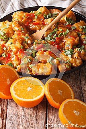 Delicious orange chicken fillets close-up on the table. vertical Stock Photo