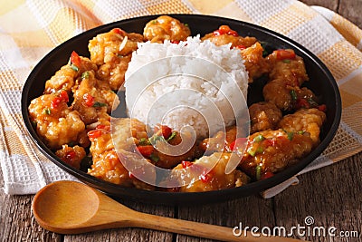 Delicious orange chicken with rice garnish close up. horizontal Stock Photo