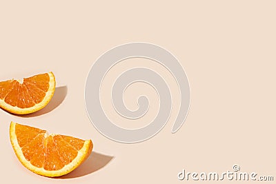 Delicious orange citrus fruit pieces on a light orange background Stock Photo