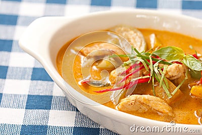 Delicious orange Thai panang curry in white bowl Stock Photo