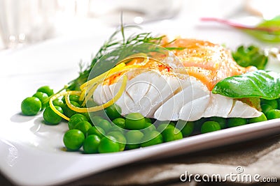 Delicious oven baked fish fillet with peas Stock Photo