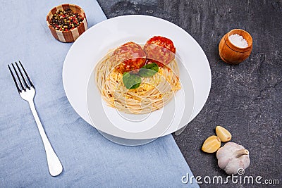 Delicious pasta with cheese and two meatballs, garlic and spices. View from above. Stock Photo