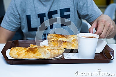 Delicious pastries with a mug of cocoa. A man sits in a cafe and dines Stock Photo