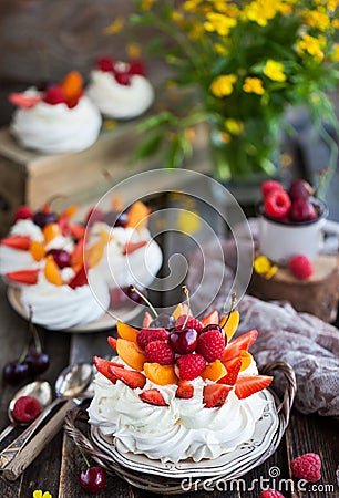 Delicious Pavlova meringue cake decorated with fresh berries Stock Photo