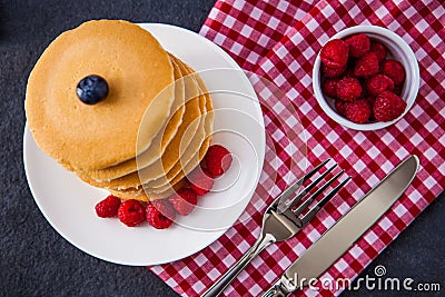 Delicious pile of hot homemade pancakes with fresh raspberries Stock Photo