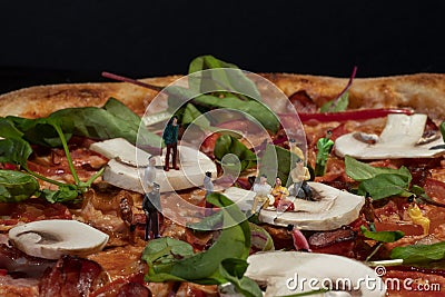 delicious pizza with fresh herbs close-up on a black background Stock Photo