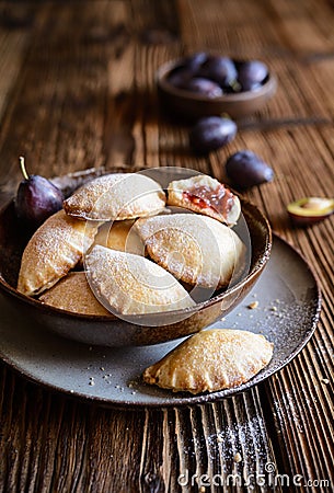 Plum pocket pies studded with powdered sugar Stock Photo