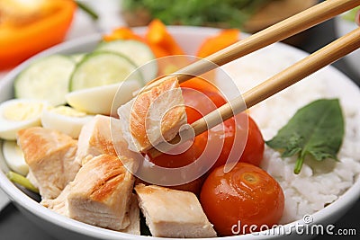 Delicious poke bowl with meat, rice, eggs and vegetables, closeup Stock Photo