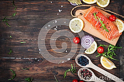 Delicious portion of fresh salmon fillet with aromatic herbs, spices and vegetables - healthy food, diet or cooking concept. Top v Stock Photo