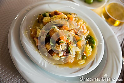 Delicious prawns, clams and calamari stewed with sauce and vegetables Stock Photo