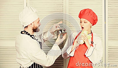 Delicious proposal. Man chef offer dessert or meal under cloche to girl. Will you eat my meal. Culinary family. Woman Stock Photo