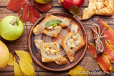 Delicious puff pastries with apples, plums and cinnamon Stock Photo