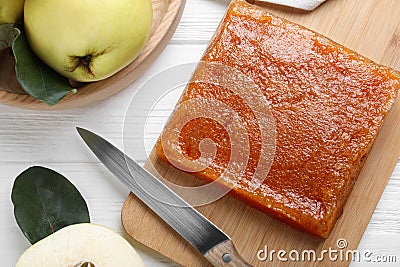Delicious quince paste and fresh fruit on white wooden table, flat lay Stock Photo