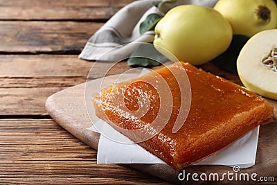 Delicious quince paste on wooden table, closeup. Space for text Stock Photo