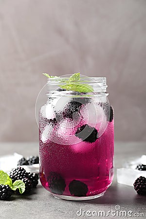 Delicious refreshing blackberry lemonade on grey table Stock Photo