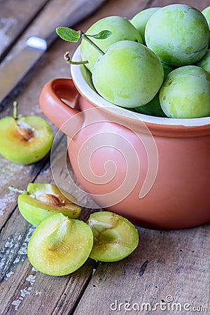 Delicious ripe plums in pot Stock Photo