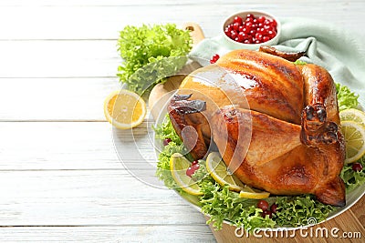 Delicious roasted turkey for traditional festive dinner on wooden table Stock Photo