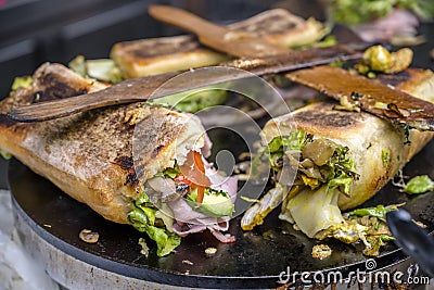 Delicious Sandwiches with crispy bread and vegetables and cheese and ham and spices baked on the stove Stock Photo