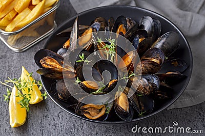 Delicious seafood mussels with parsley sauce and lemon. Delicious steamed mussels Stock Photo
