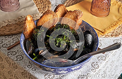 Delicious seafood mussels with parsley and toast. Clams in the shells.Food concept Stock Photo