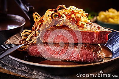 Delicious serving of rare roast joint with fried onions Stock Photo