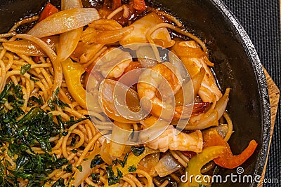 Delicious shrimp and onion spaghetti in sizzling iron platter Stock Photo