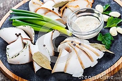 Delicious sliced pork fat with spices, green onions, garlic and Stock Photo