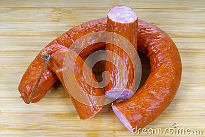Delicious sliced smoked sausage on bamboo cuting board Stock Photo