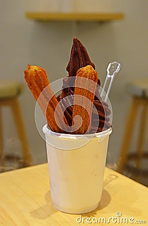 Delicious Soft serve ice cream chocolate flavour and churros with foggy effect Stock Photo