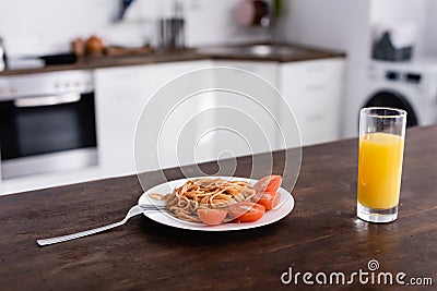 Spaghetti and tomato on plate near Stock Photo