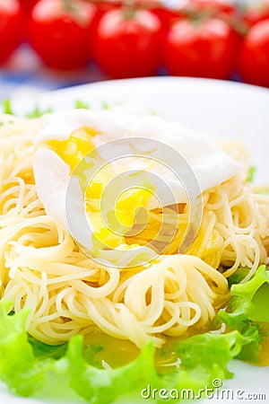 Delicious spaghetti with tomato and poached egg Stock Photo