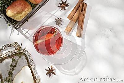 Delicious spicy hot mulled red wine with cinnamon, star anise and slice pear served in a carafe and glass for a cold winter Stock Photo