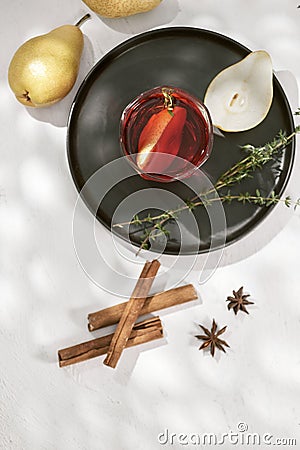 Delicious spicy hot mulled red wine with cinnamon, star anise and slice pear served in a carafe and glass for a cold winter Stock Photo