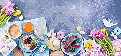 Delicious spring breakfast on a gray stone background. A bouquet of fresh tulips of pink and mint color. Small and large colored Stock Photo