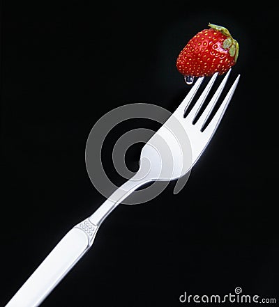 Delicious strawberry on a fork Stock Photo