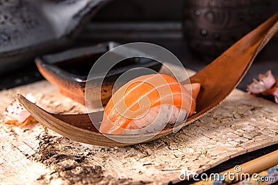 Delicious Sushi Nigiri with Salmon. Dish decorated with a sprig of cherry blossoms. Stock Photo