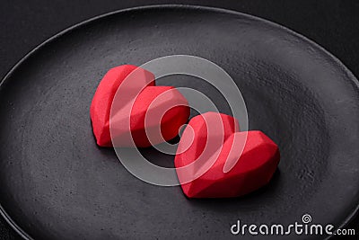 Delicious sweet heart shaped chocolate candies on a dark concrete background Stock Photo