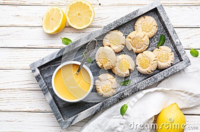 Delicious sweet snack, lemon crud thumbprint cookies sprinkled with powdered sugar Stock Photo