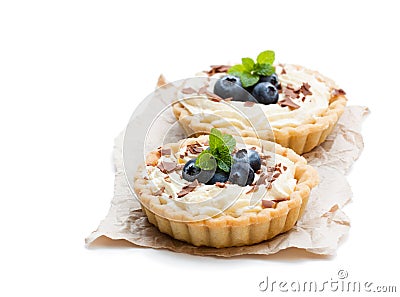 Delicious tarts with cream and fresh blueberry isolated on whit Stock Photo